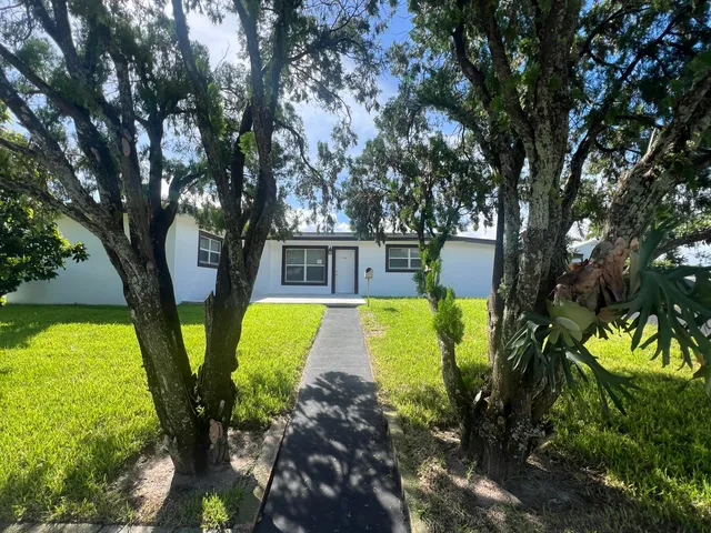 a view of swimming pool with sitting area and garden