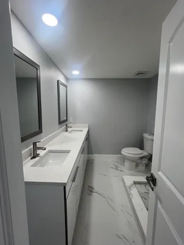 a bathroom with a sink toilet and shower
