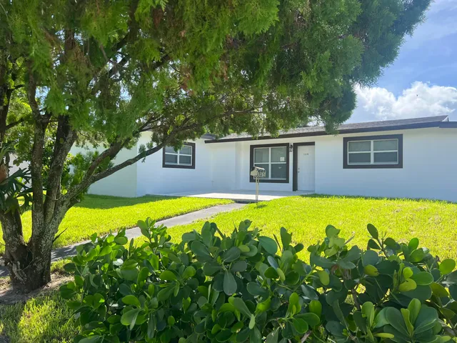 a swimming pool with outdoor seating and yard
