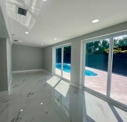 a view of a kitchen with a refrigerator a sink and a window