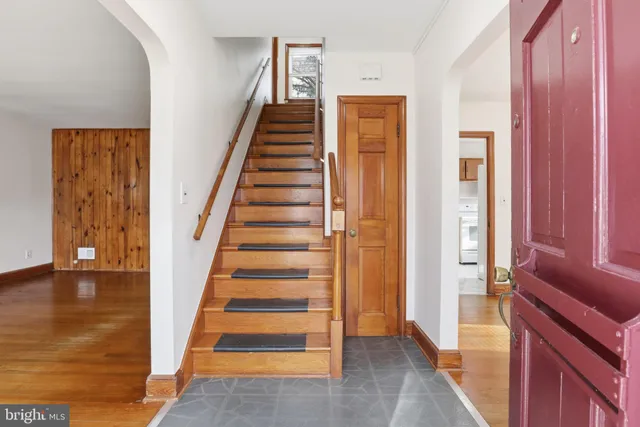 a view of a hallway with wooden floor and entryway