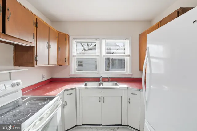 a utility room with cabinets washer and dryer