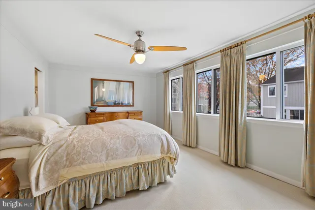 a bedroom with a bed and large window