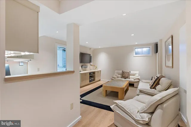 a living room with furniture and kitchen view