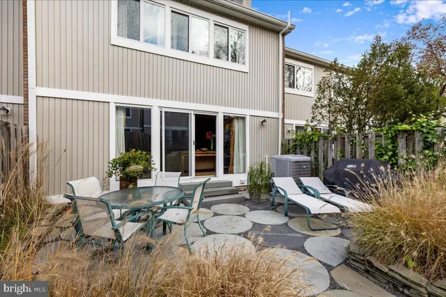 a view of a house with backyard sitting area and garden