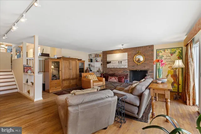 a living room with furniture a fireplace and a window
