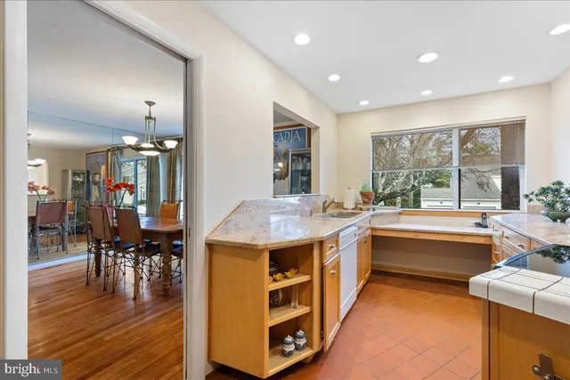 a kitchen with a stove and wooden floor