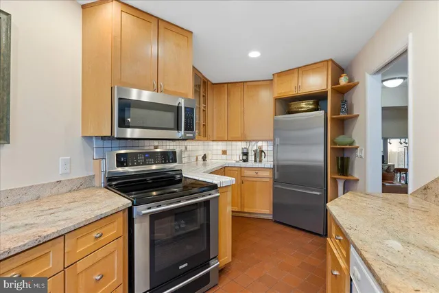 a kitchen with a refrigerator stove and microwave
