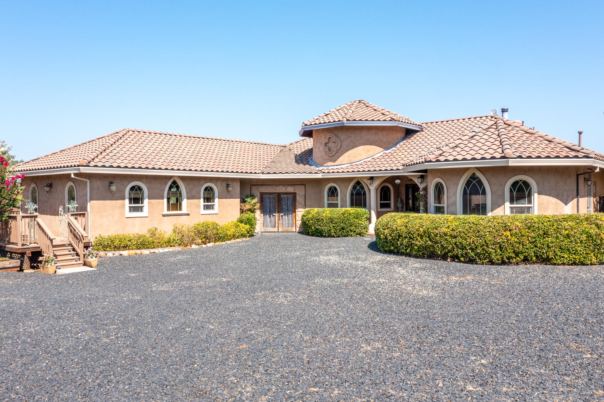 a front view of a house with a garden