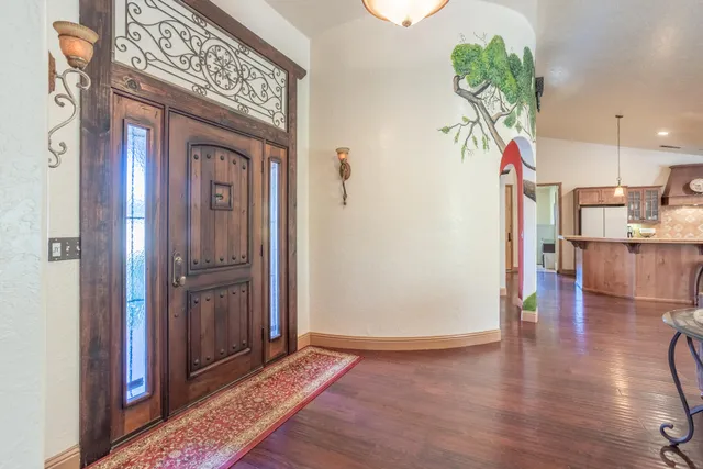 a bedroom with a bed mirror and a large window