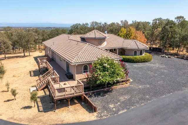 aerial view of a house with a yard and furniture