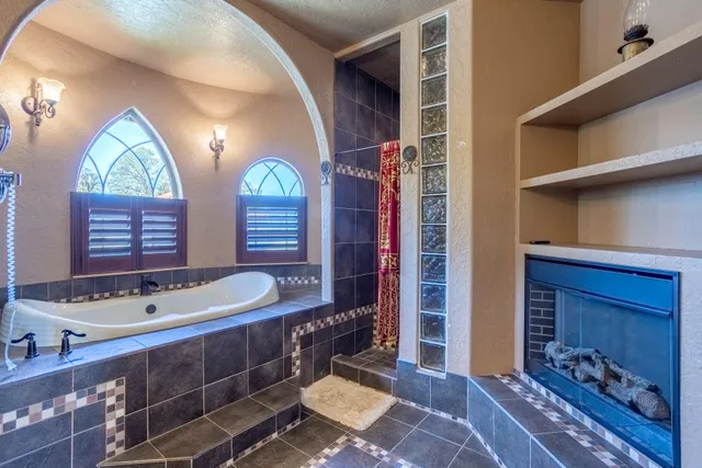 a bathroom with a bathtub and a shower
