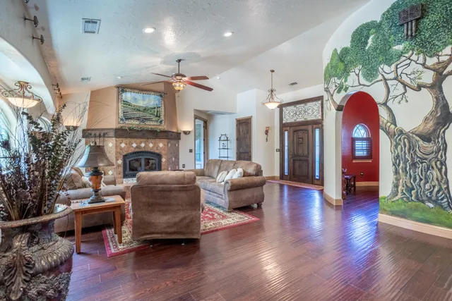 a living room with furniture a fireplace and a potted plant
