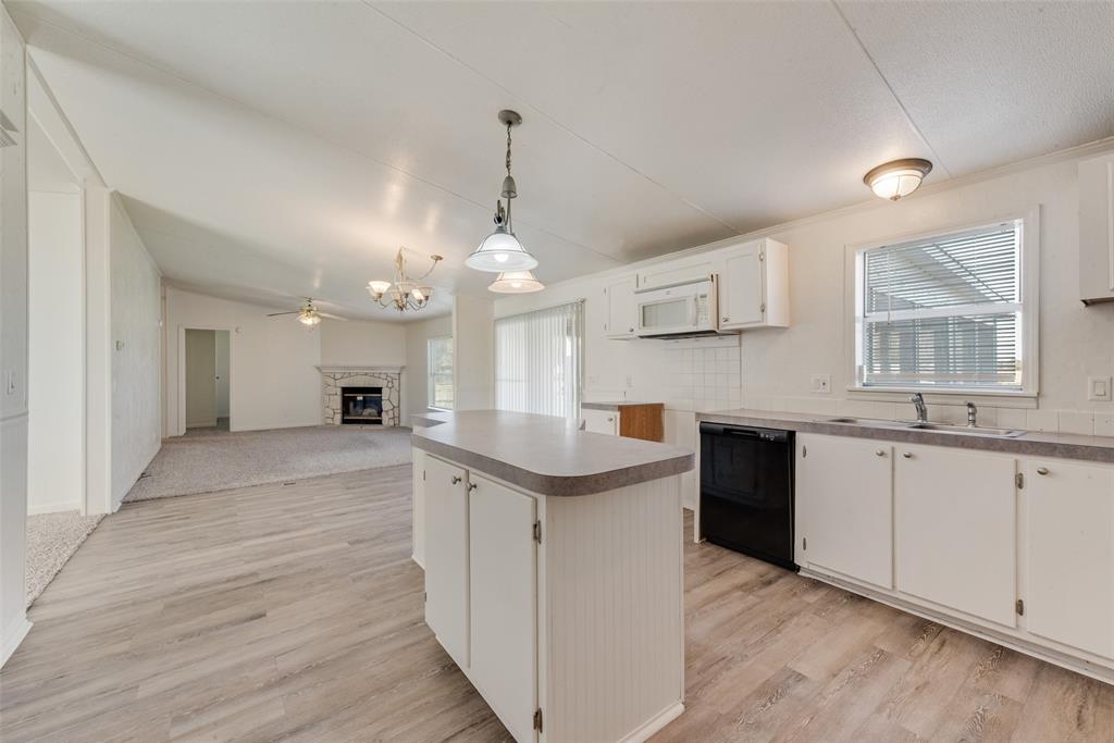 817 Kaufman Street Rosser, TX 75158 - Photo 29 of 29 a kitchen with granite countertop a sink cabinets and window