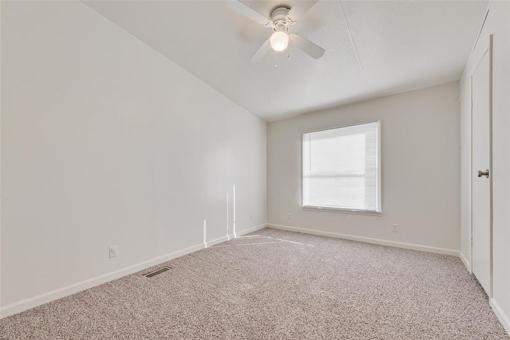 817 Kaufman Street Rosser, TX 75158 - Photo 17 of 29 an empty room with a window and a fan
