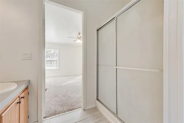 a bathroom with a bathtub a mirror a sink and vanity