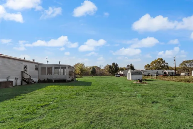 a view of a backyard with plants and a garden