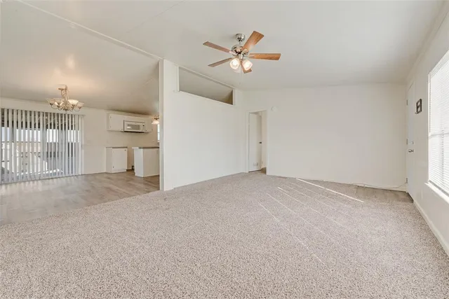 an empty room with fireplace and fan