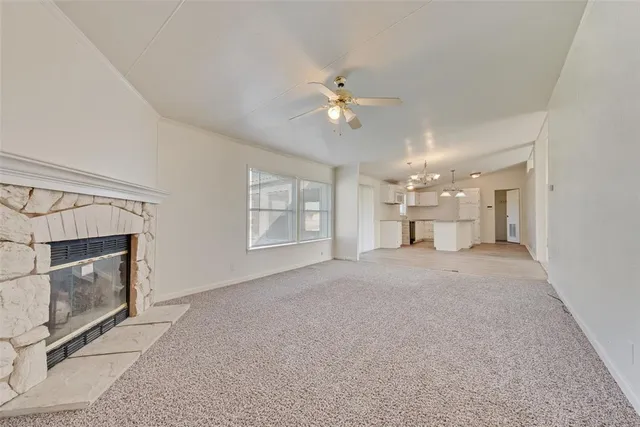 a view of a big room with wooden floor and kitchen