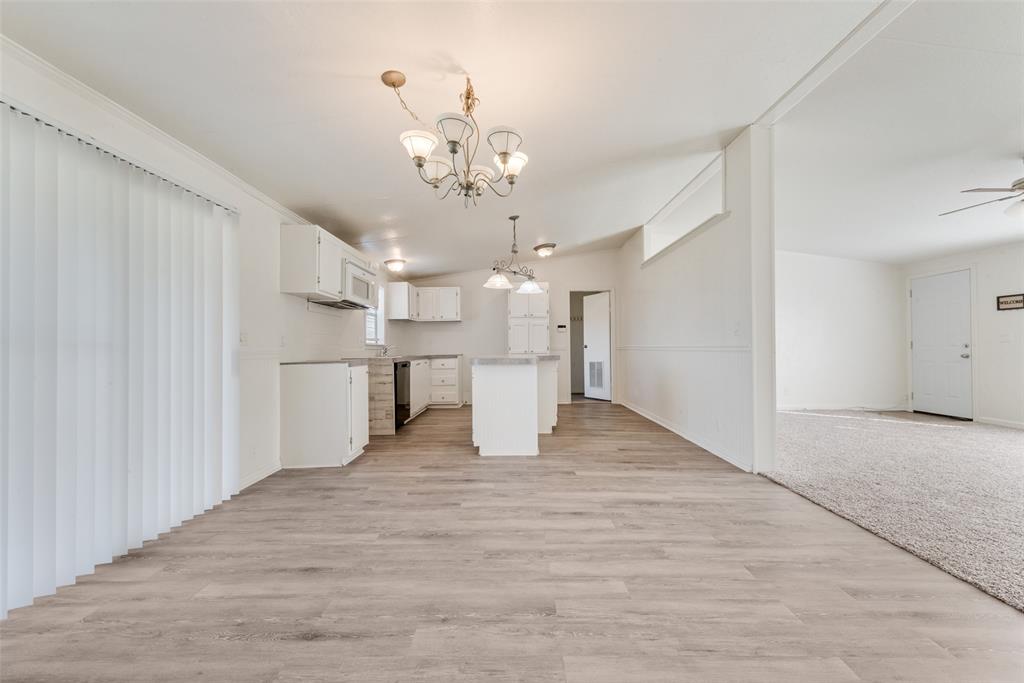 817 Kaufman Street Rosser, TX 75158 - Photo 28 of 29 a view of a big room with wooden floor and kitchen