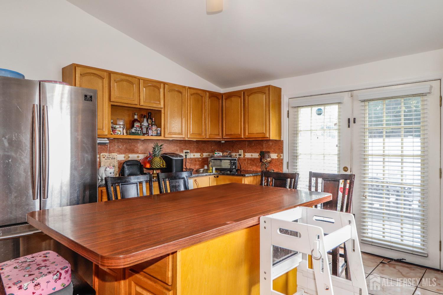76 Daniel Street Carteret, NJ 07008 - Photo 14 of 37 a open kitchen with stainless steel appliances granite countertop a refrigerator a stove a sink dishwasher and a dining table with the kitchen view