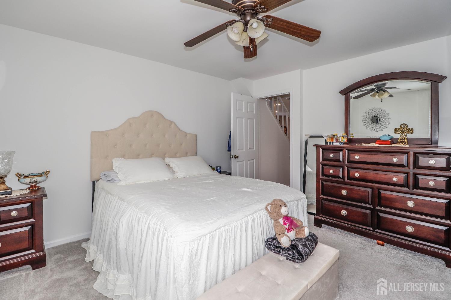 76 Daniel Street Carteret, NJ 07008 - Photo 18 of 37 a bedroom with a bed and a chandelier