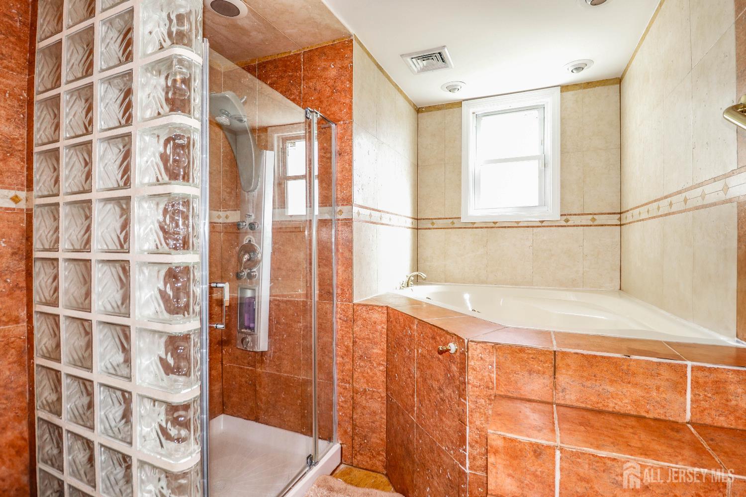76 Daniel Street Carteret, NJ 07008 - Photo 19 of 37 a bathroom with a granite countertop sink and a bathtub