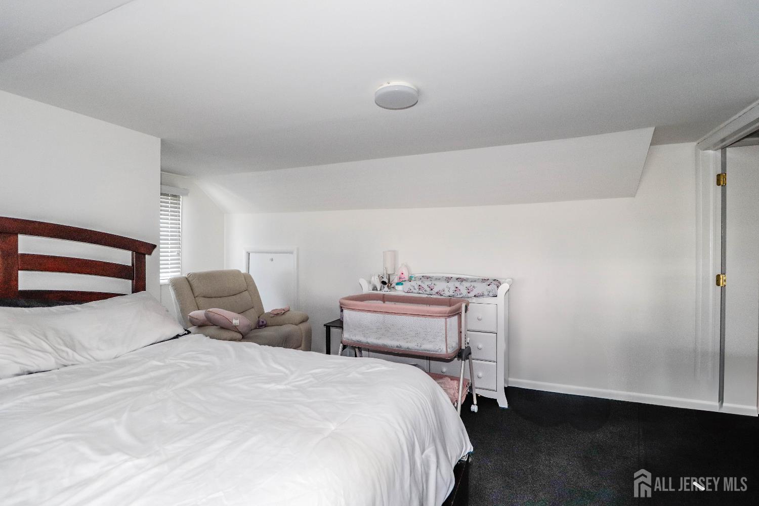 76 Daniel Street Carteret, NJ 07008 - Photo 22 of 37 a bedroom with a bed and a night stand