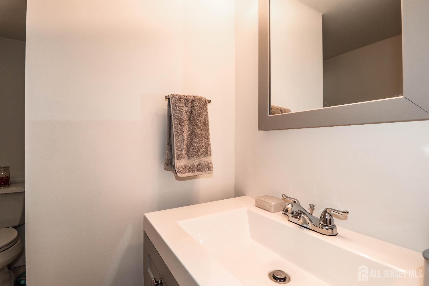 76 Daniel Street Carteret, NJ 07008 - Photo 23 of 37 a bathroom with a sink and a mirror