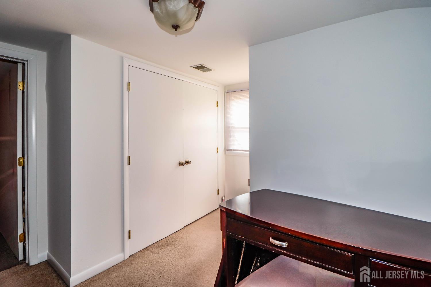 76 Daniel Street Carteret, NJ 07008 - Photo 27 of 37 a room with a chair and a window