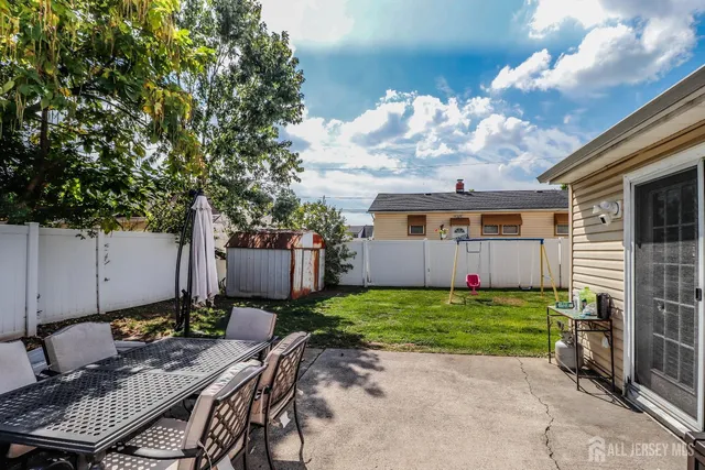 a view of a house with backyard and sitting area