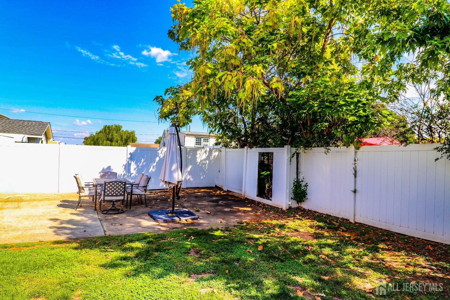 76 Daniel Street Carteret, NJ 07008 - Photo 32 of 37 a backyard of a house with table and chairs
