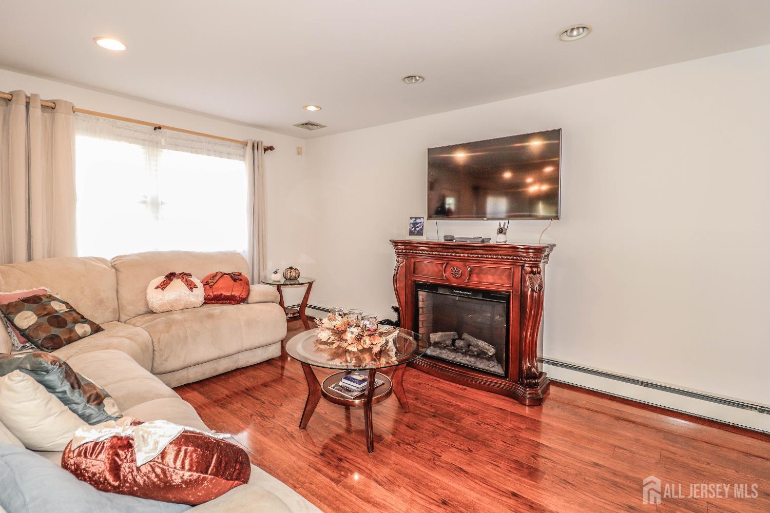 76 Daniel Street Carteret, NJ 07008 - Photo 6 of 37 a living room with furniture and a fireplace