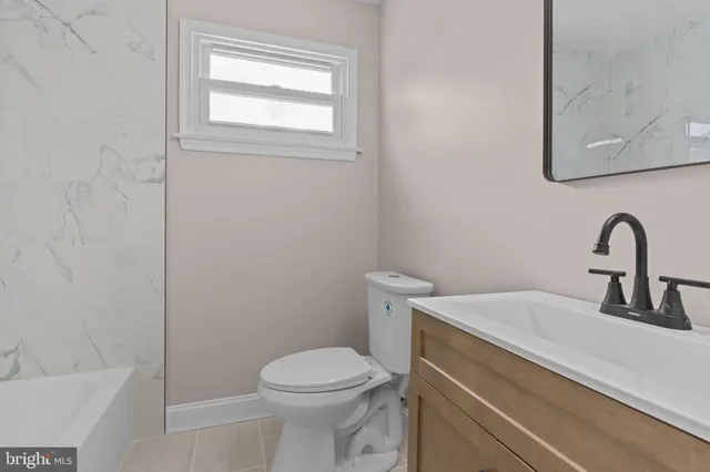 a bathroom with a sink a toilet and a bathtub