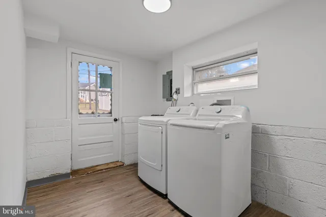 a utility room with cabinets washer and dryer