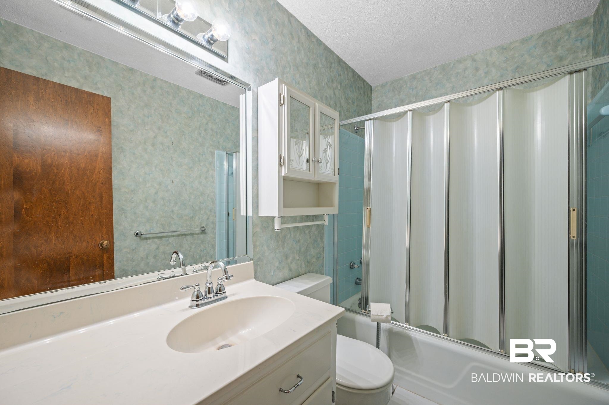 950 Walter Smith Road Mobile, AL 36695 - Photo 24 of 51 Bathroom featuring wallpapered walls, toilet, vanity, and bath / shower combo with glass door