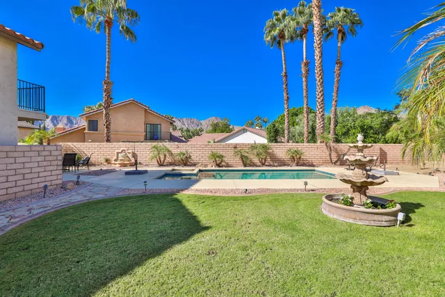 a view of a house with swimming pool and sitting area