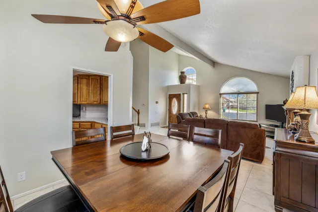 a view of a dining room with furniture and a chandelier