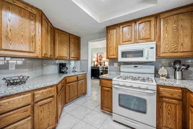 a kitchen with granite countertop cabinets stainless steel appliances and a sink