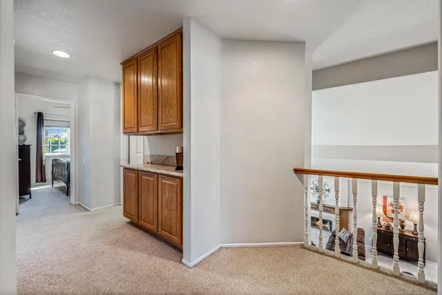 a spacious bedroom with a bed and a chandelier