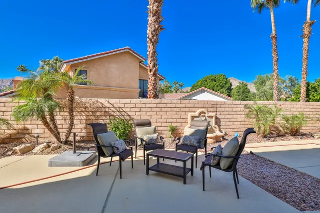 a view of a patio with table and chairs and potted plants
