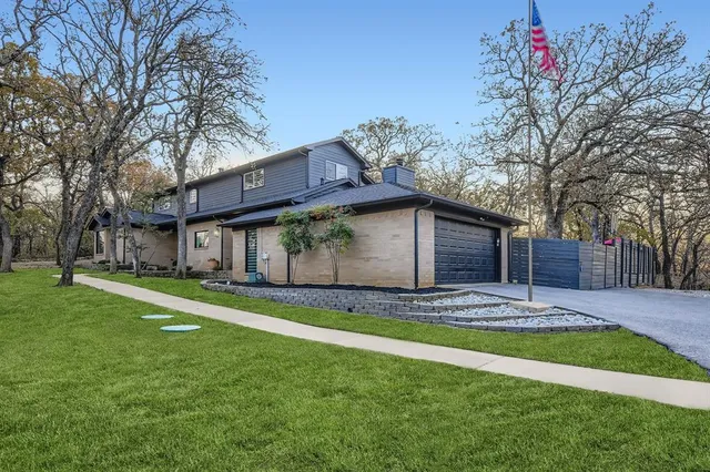 a view of a house with a yard and tree s
