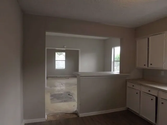 a view of a kitchen cabinets and a window
