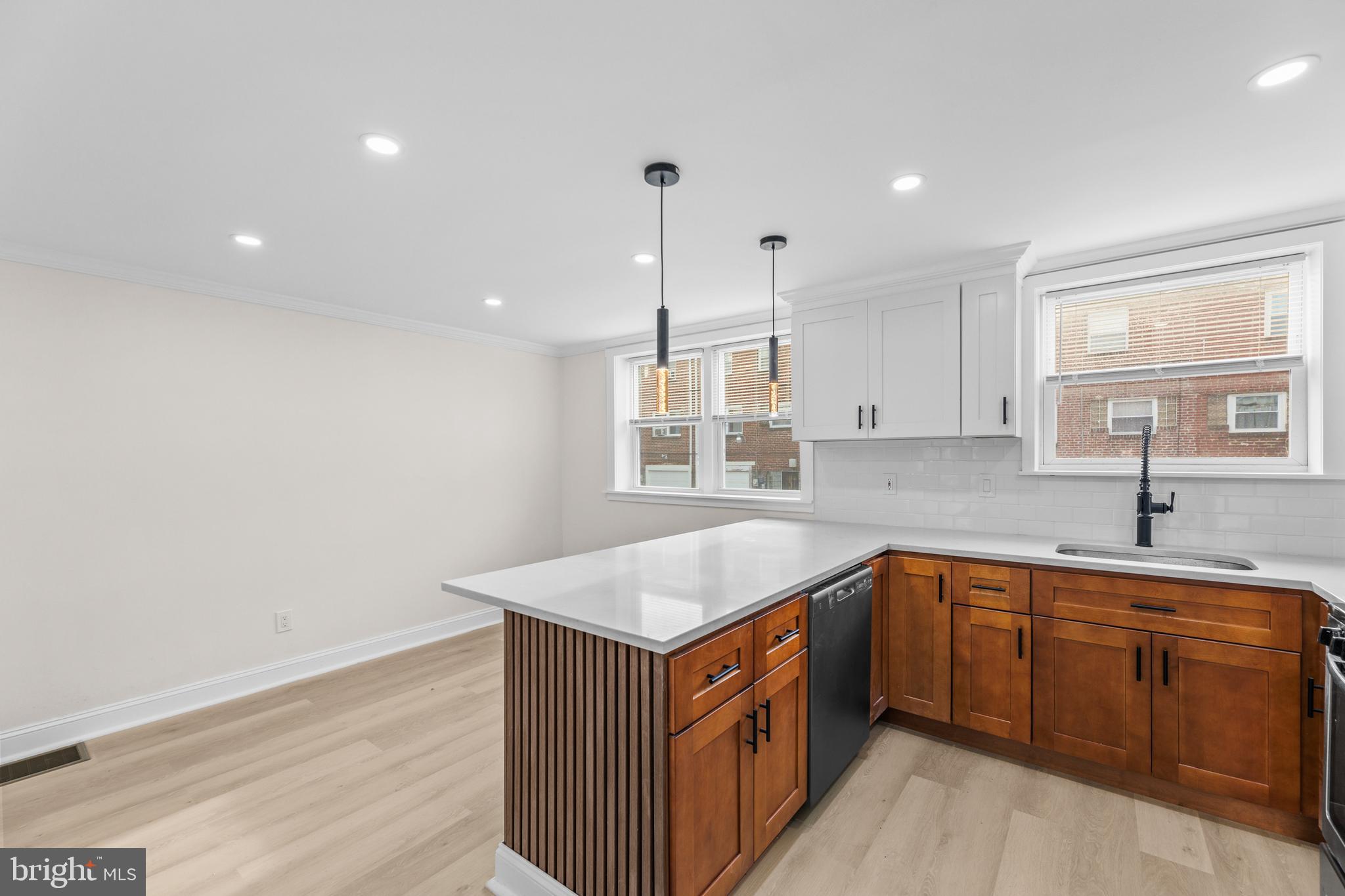 7920 Provident Street Philadelphia, PA 19150 - Photo 12 of 32 a kitchen with a sink window and cabinets