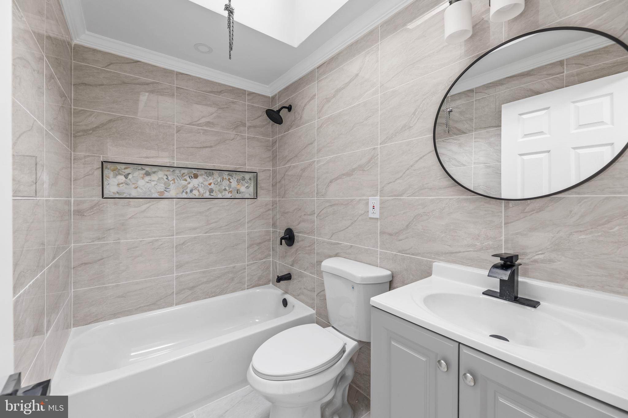 7920 Provident Street Philadelphia, PA 19150 - Photo 16 of 32 a bathroom with a sink a toilet and a mirror