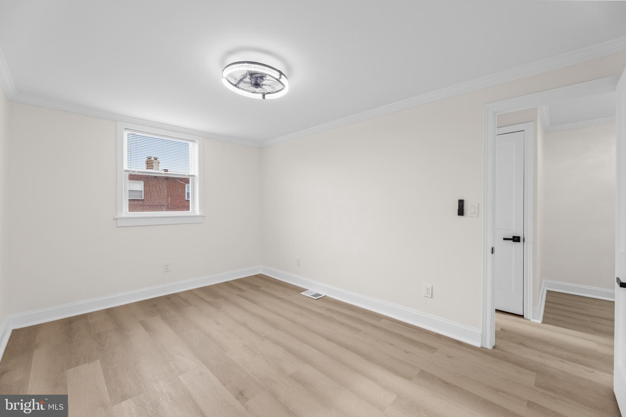 7920 Provident Street Philadelphia, PA 19150 - Photo 18 of 32 an empty room with wooden floor and windows
