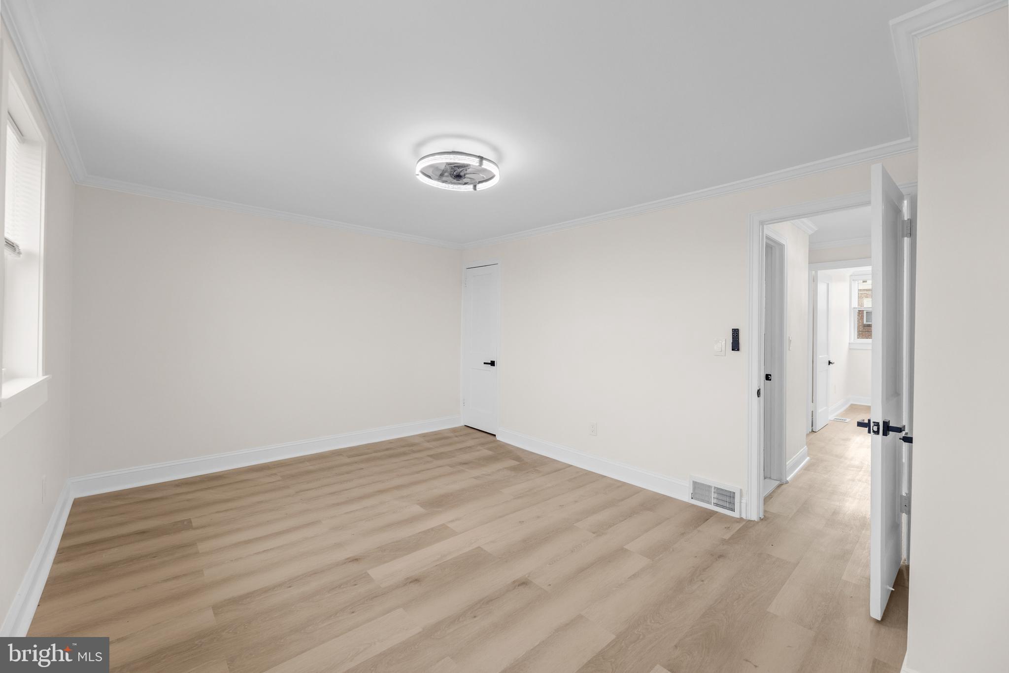 7920 Provident Street Philadelphia, PA 19150 - Photo 23 of 32 an empty room with wooden floor and a window