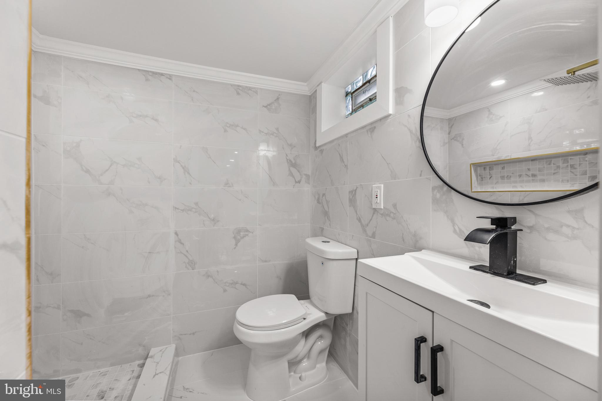 7920 Provident Street Philadelphia, PA 19150 - Photo 28 of 32 a bathroom with a sink a toilet and a mirror