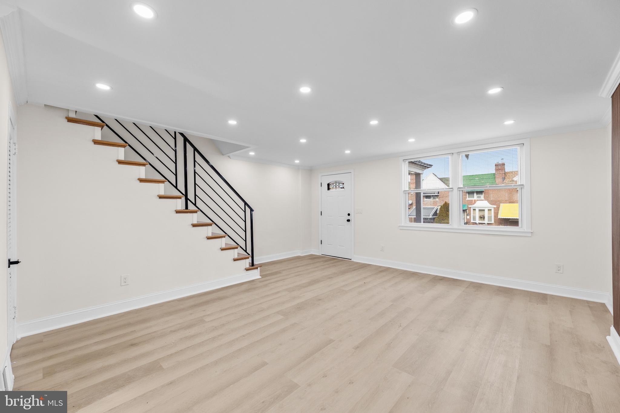 7920 Provident Street Philadelphia, PA 19150 - Photo 10 of 32 an empty room with wooden floor and entryway