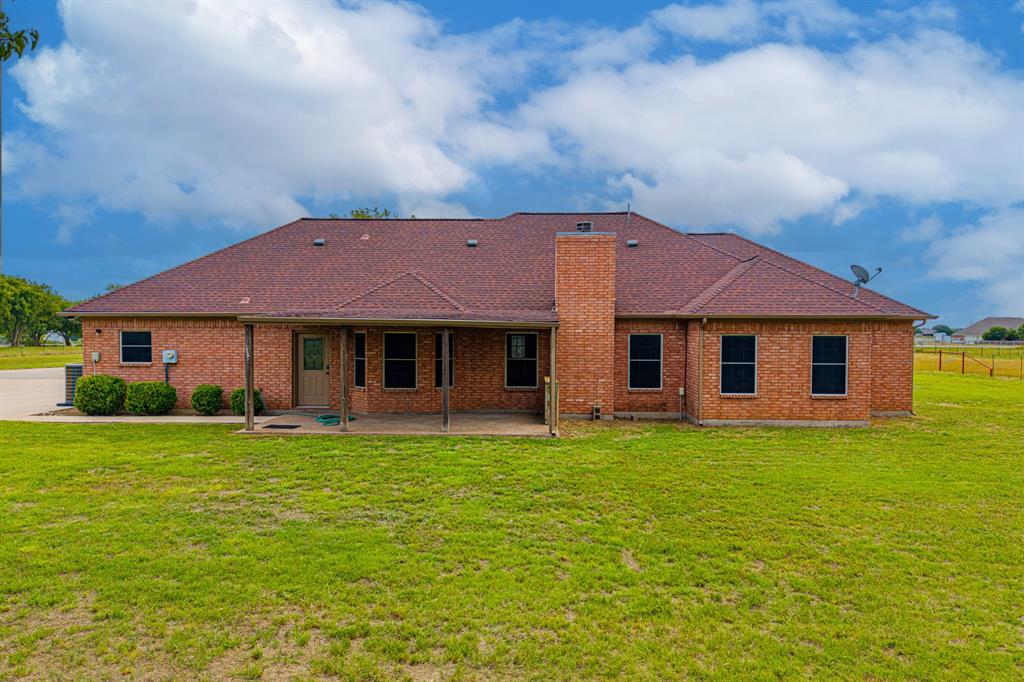 483 Christy Kay Lane Rhome, TX 76078 - Photo 37 of 40 a front view of a house with a garden